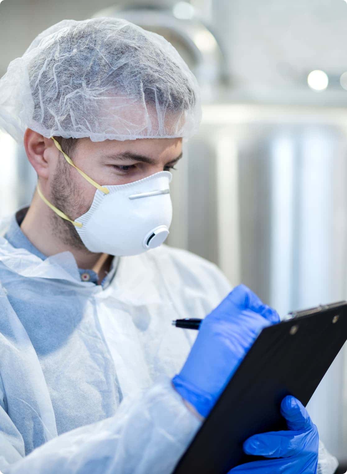 food safety consultant writing notes on tablet